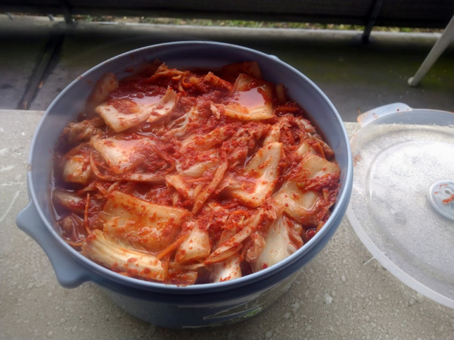 Fresh kimchi in a plastic container